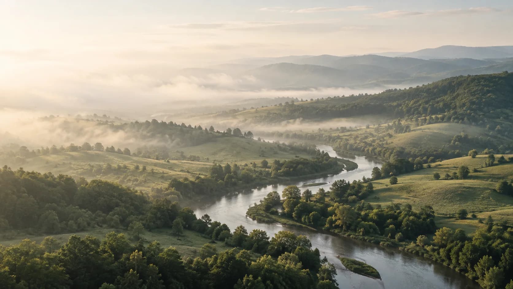 A river winding through quiet green hills